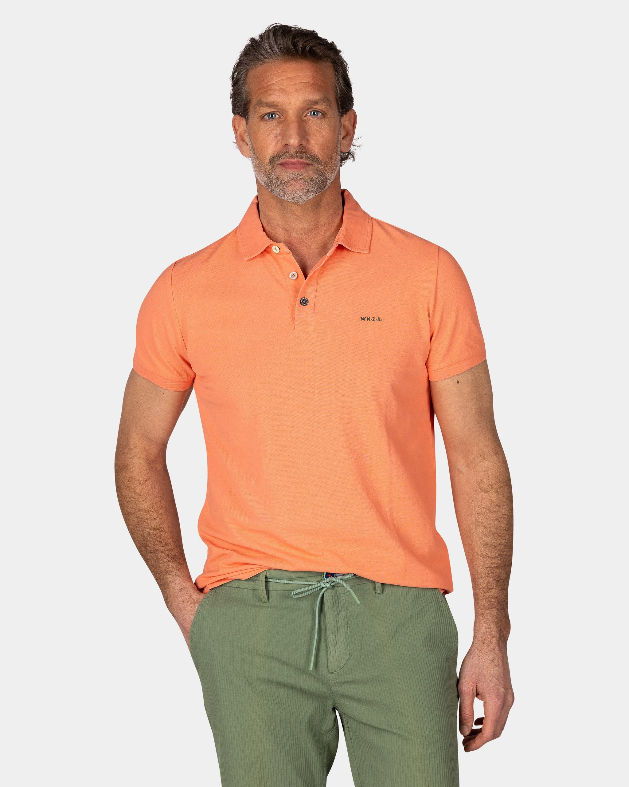 Effen katoenen koraalkleurige polo Effen katoenen koraalkleurige polo