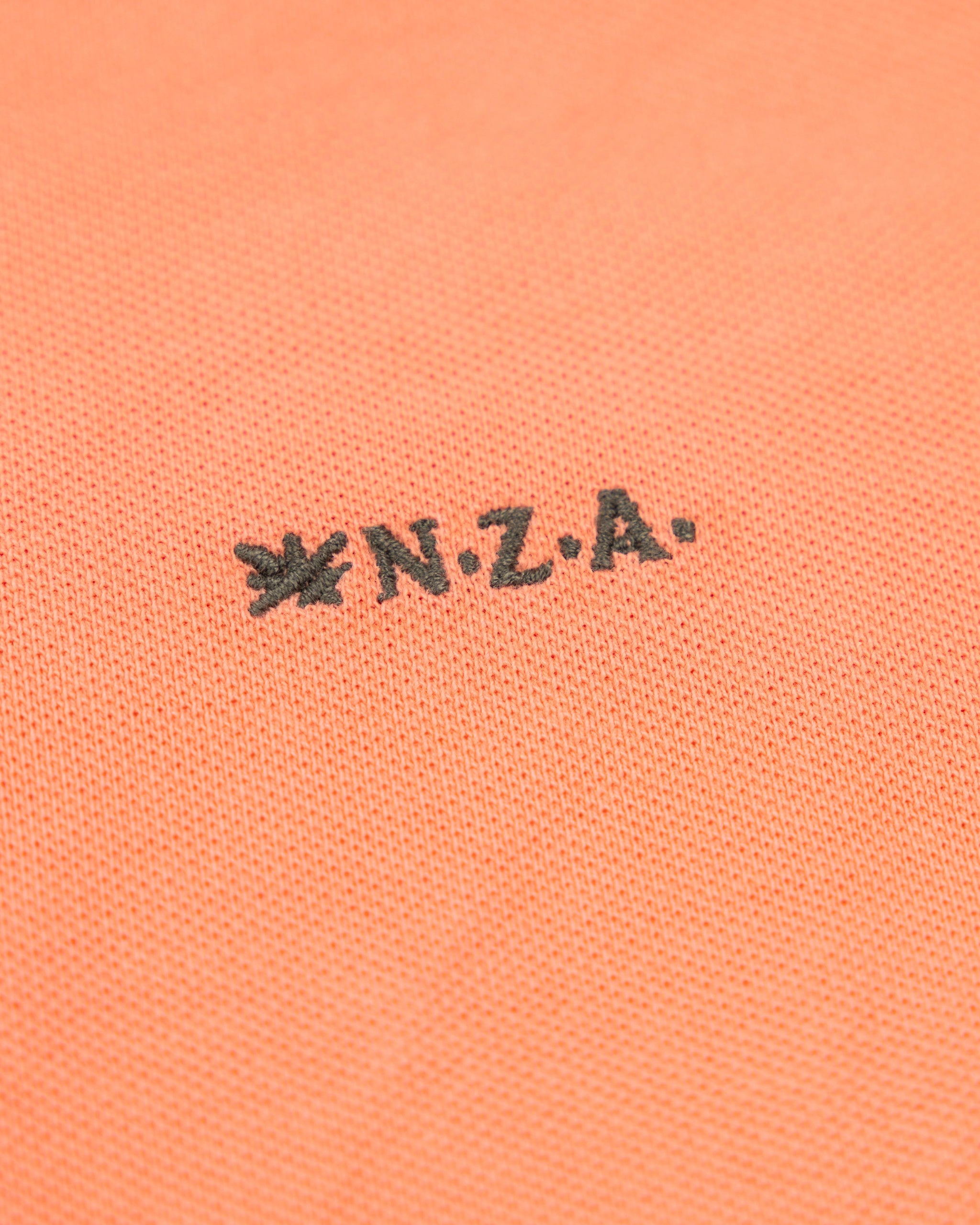 Effen katoenen koraalkleurige polo Effen katoenen koraalkleurige polo