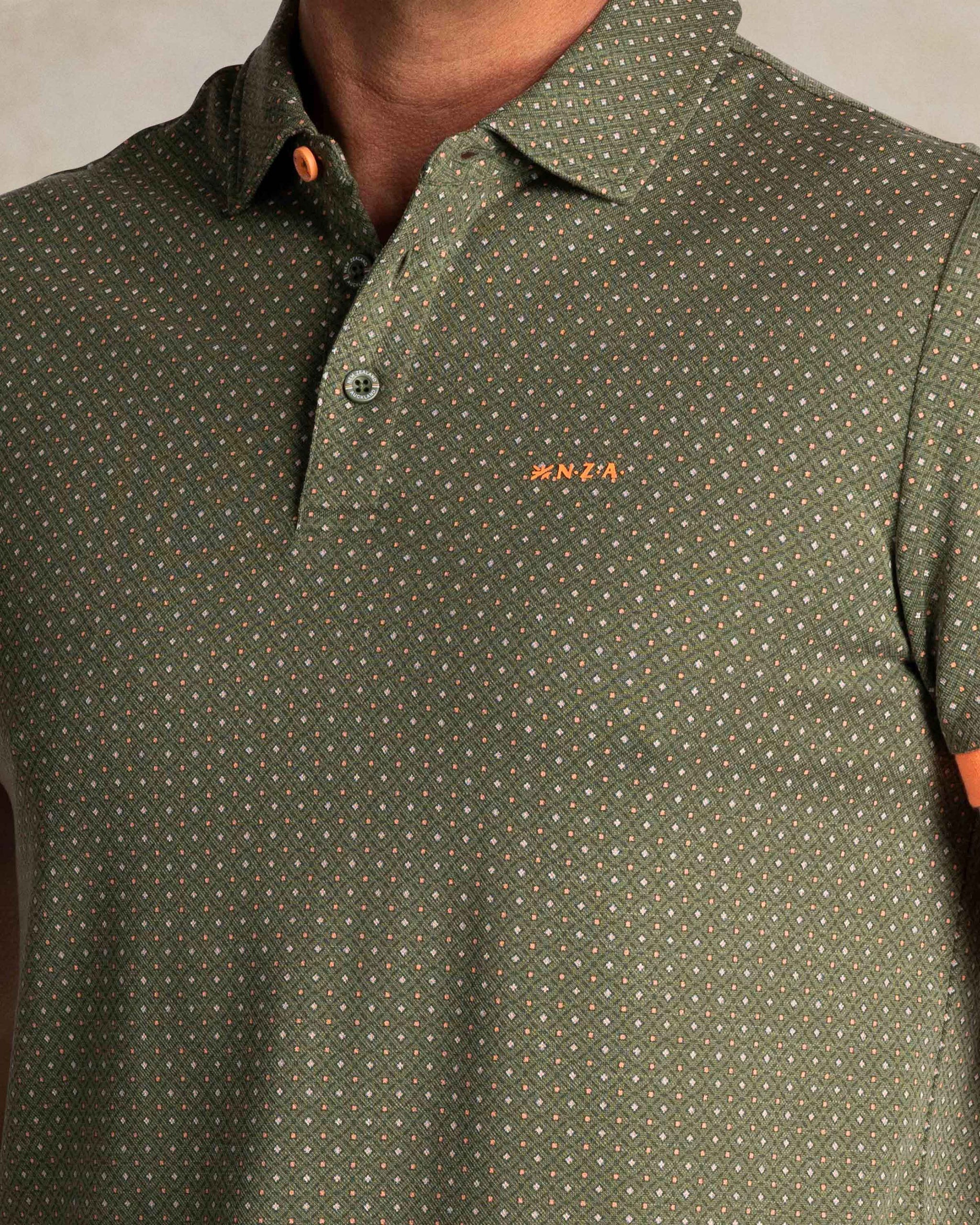 Green polo with small orange dots Green polo with small orange dots