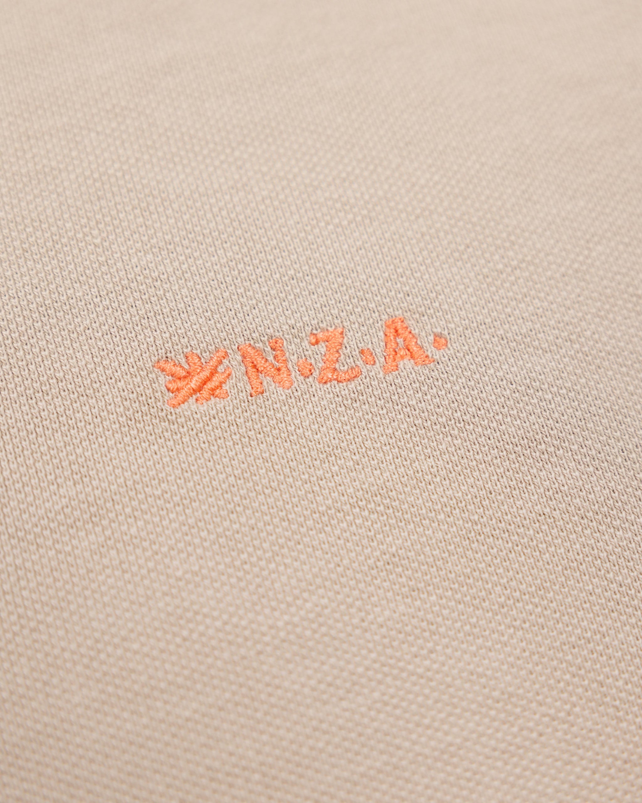 Effen katoenen zandkleurige polo Effen katoenen zandkleurige polo