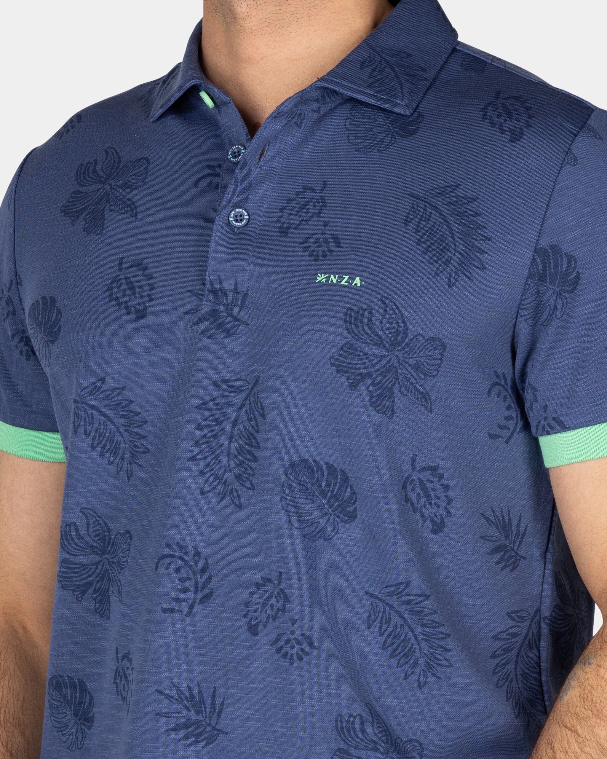 Blauw poloshirt met bladprint Blauw poloshirt met bladprint