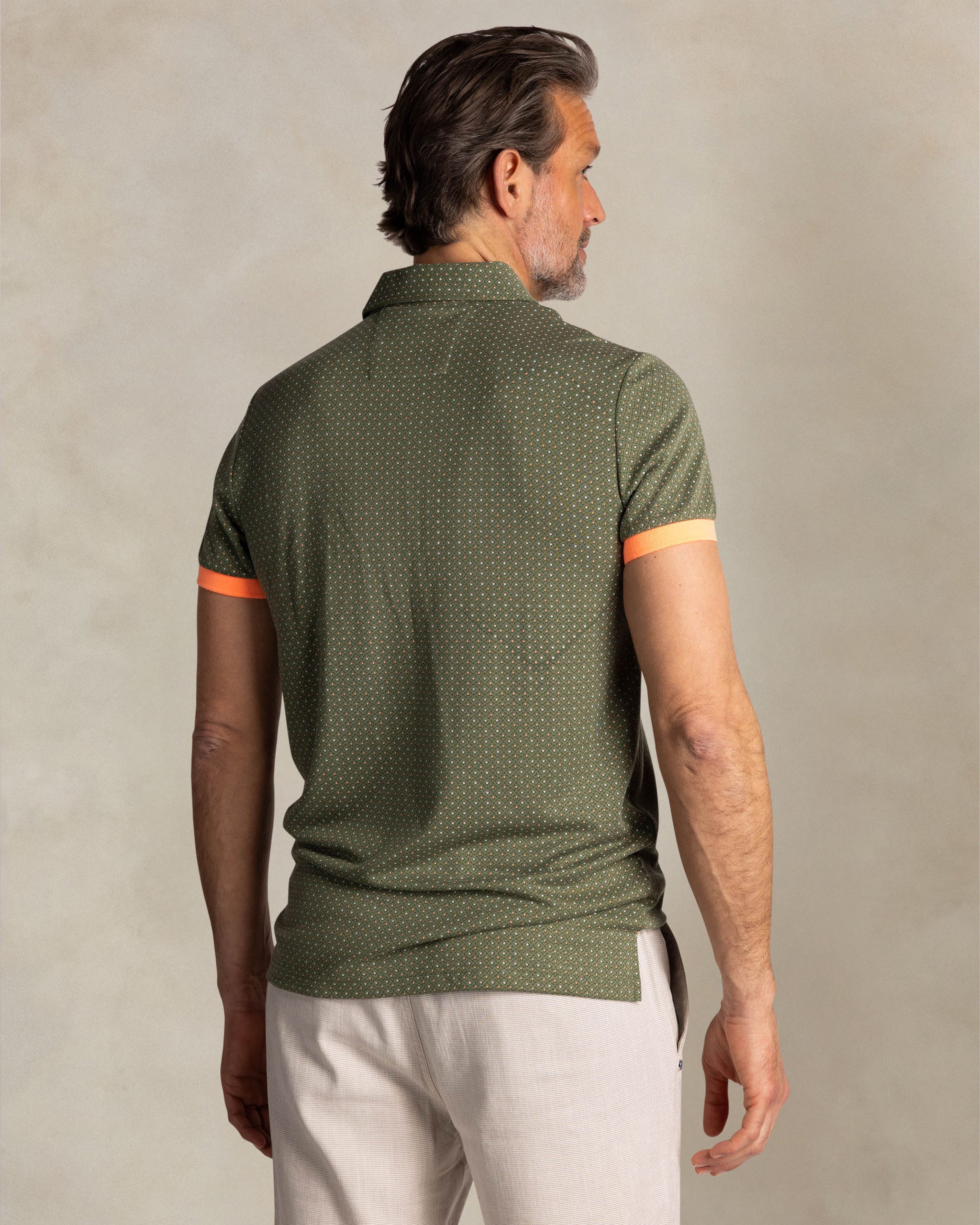 Green polo with small orange dots Green polo with small orange dots