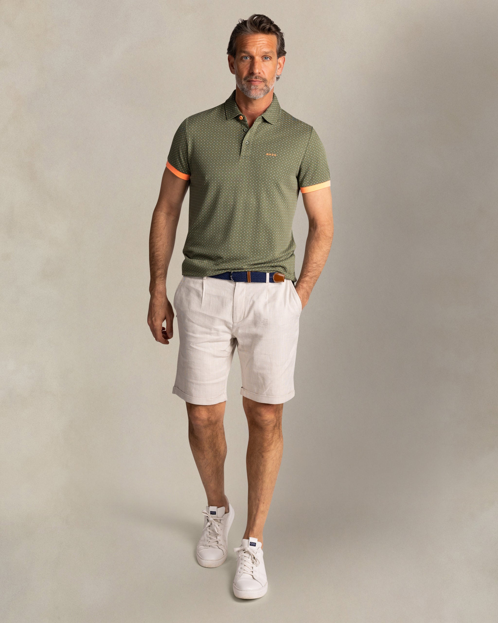 Green polo with small orange dots Green polo with small orange dots